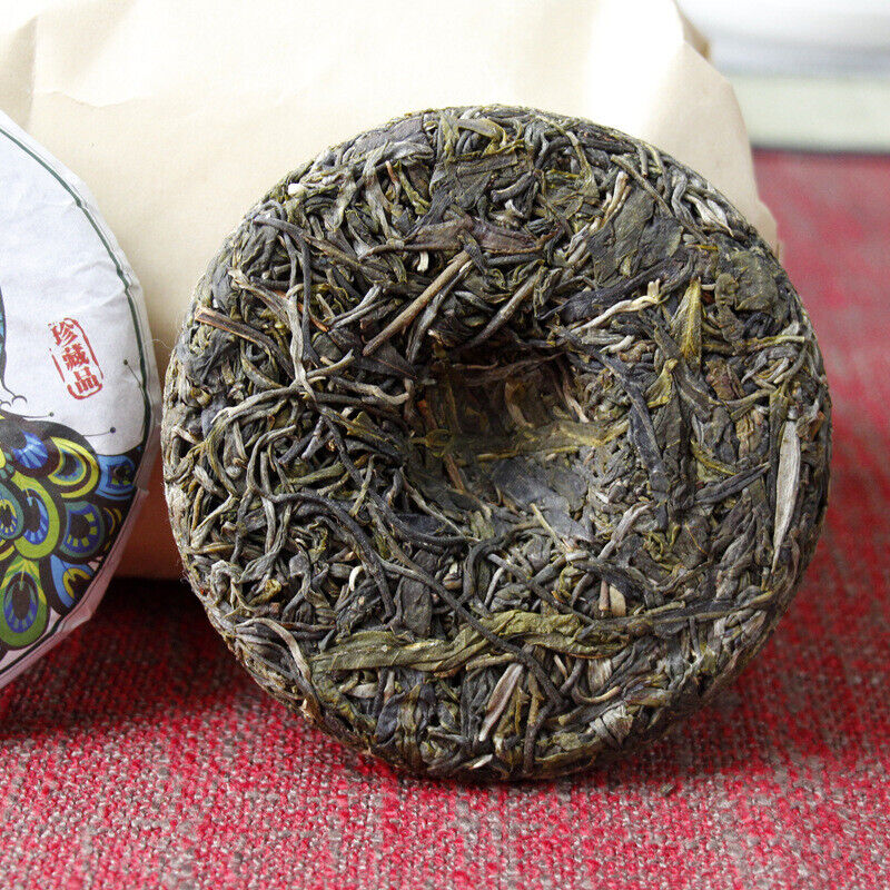 HelloYoung 100g Yunnan Pu'er tea Icelandic raw peacock green cake seven cakes Mengku tea