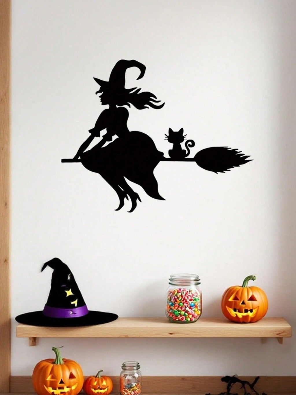 Midnight Witch Wall Art: An intricately crafted iron silhouette of a witch soaring on a broomstick under the moonlight. This Halloween-themed black metal wall ornament features delicate butterfly accents, adding a mystical charm to your space. Perfect as