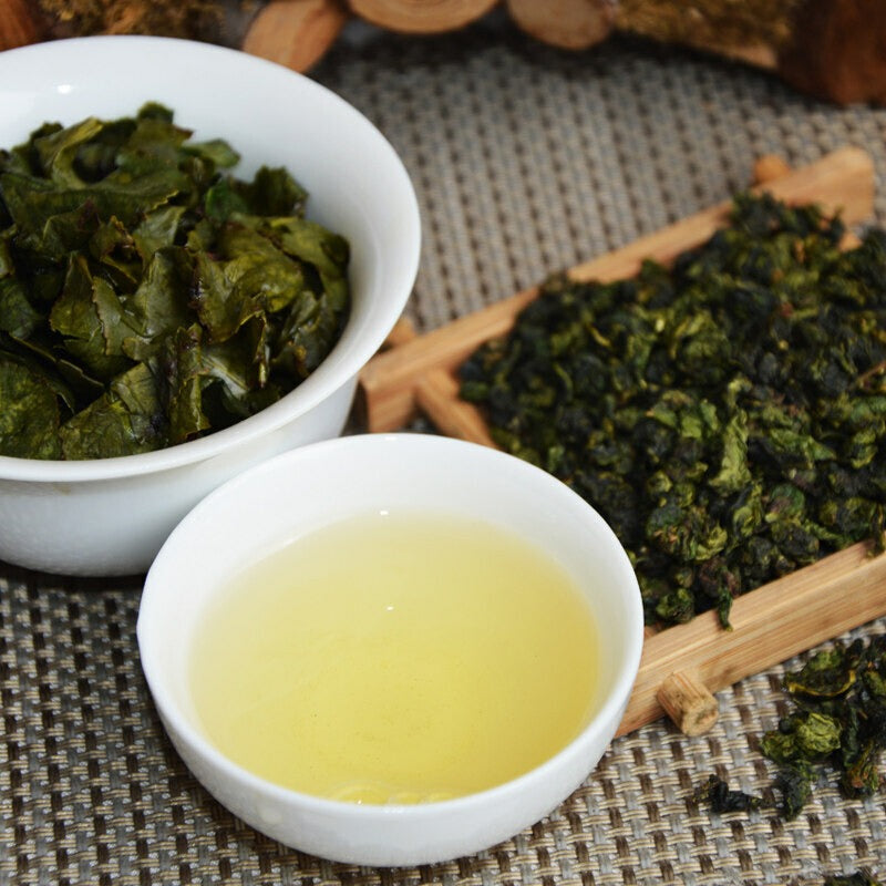 Golden amber Tie Guan Yin Oolong Tea infusion in a cup showing clear tea liquor and refreshing premium tea experience