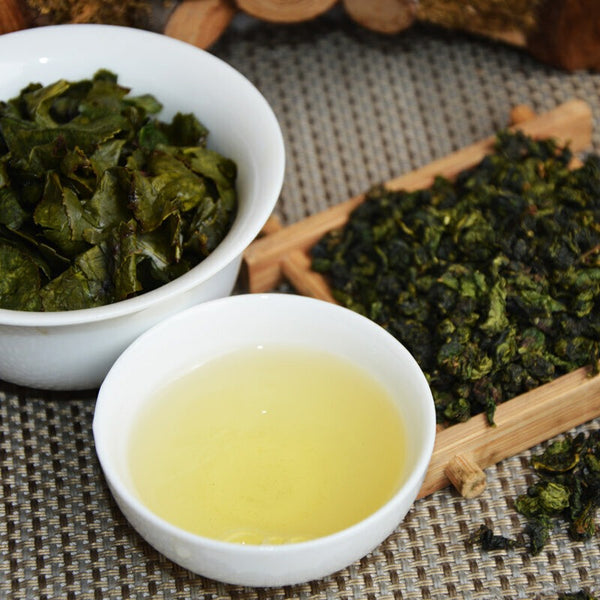 Golden amber Tie Guan Yin Oolong Tea infusion in a cup showing clear tea liquor and refreshing premium tea experience