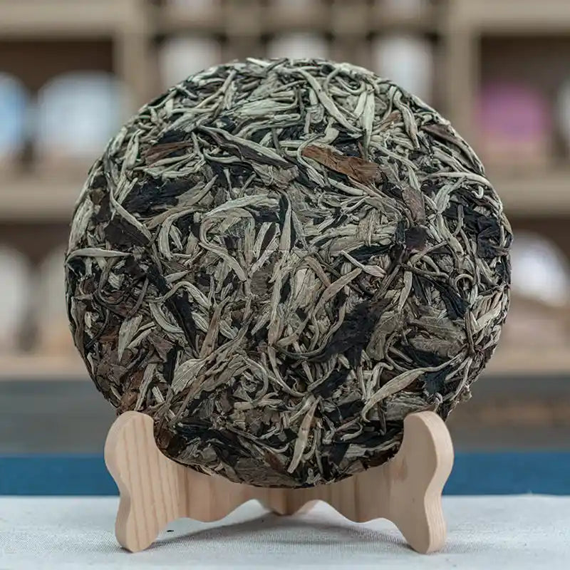 Premium artisan Yunnan whole tea leaves displaying rich texture and intact white tea buds.