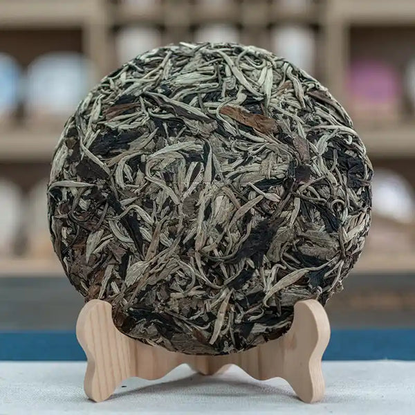 Premium artisan Yunnan whole tea leaves displaying rich texture and intact white tea buds.