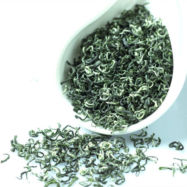 Close-up view of high-quality Biluochun green tea loose leaves showing fresh spring harvested tea leaves and natural texture