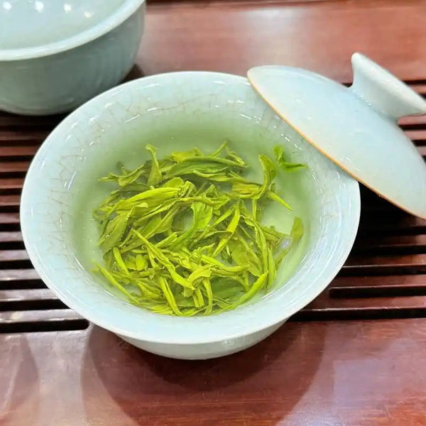 Brewed Biluochun green tea in a cup showing clear golden-green tea color and refreshing appearance
