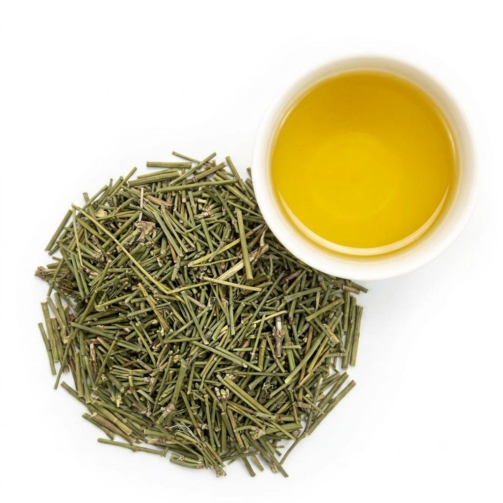 Warm clear golden liquid liquor of brewed MaHuang herbal tea in a glass cup Main image