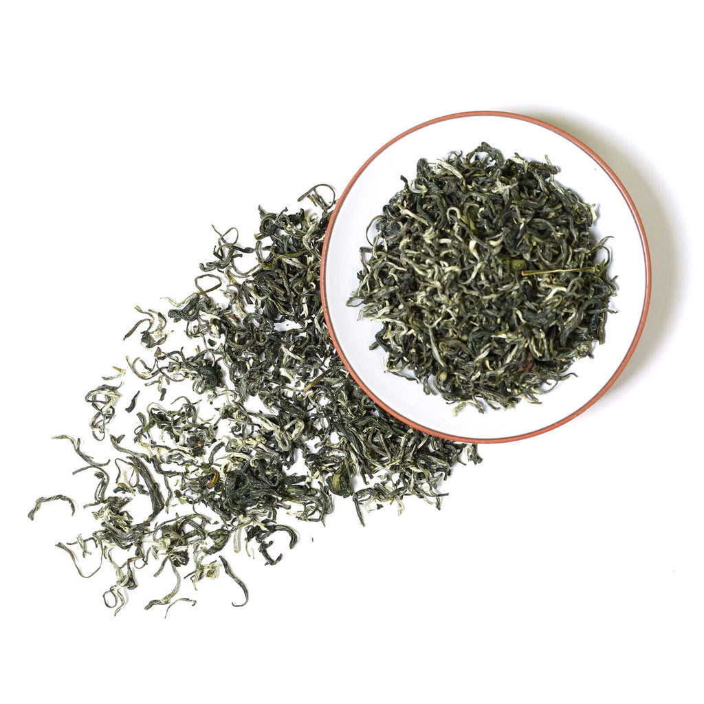 Fresh Suzhou Biluochun green tea leaves with delicate spiral shape and natural spring harvest texture
