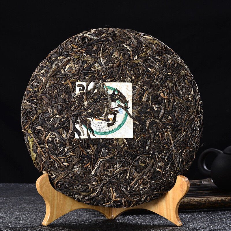 HelloYoung Tea digestive wellness tea featuring the Golden Peacock raw Pu-erh cake in its authentic 357g packaging.