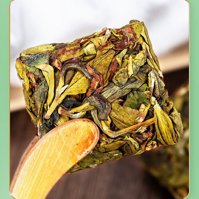Close-up of the compressed Zhangping Shui Xian oolong tea cake, revealing premium, semi-fermented leaves with roasted notes.